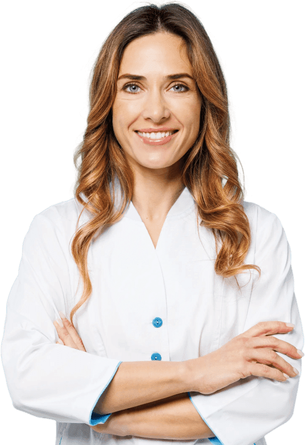 A woman with long wavy brown hair, wearing a white lab coat, stands smiling with her arms crossed against a plain light background.